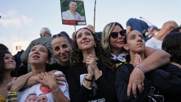 People react in anticipation of the release of Israeli hostages held in Gaza during a gathering at a plaza known as hostages square in Tel Aviv, Israel, Monday, Oct. 13, 2025.  - Sputnik Монгол Улс