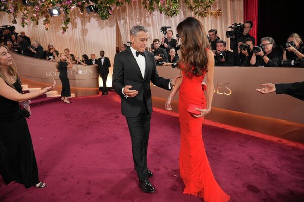 Жорж Клуни (зүүн талд) болон Амал Клуни нар 2026 оны 1-р сарын 11-ний ням гарагт Калифорни мужийн Беверли Хиллз дэх Беверли Хилтон зочид буудалд болох 83 дахь удаагийн Алтан бөмбөрцөг шагнал гардуулах ёслолд хүрэлцэн ирлээ. (Зургийг Жордан Страусс/Invision/AP авсан) - Sputnik Монгол Улс